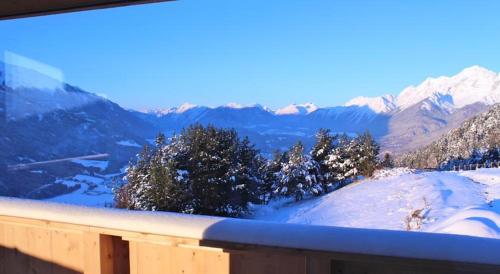 a view of a snowy mountain with trees and mountains at Appartement Seejoch in Seefeld in Tirol