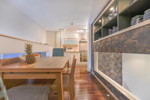 a kitchen and dining room with a wooden table at The Old School in Dean Village in Edinburgh