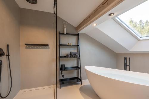 a bathroom with a skylight and a bath tub at Ferienhaus Daheim in Sankt Peter