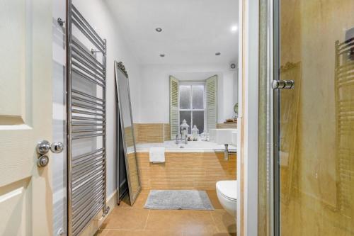 a bathroom with a tub and a toilet and a sink at The Old School in Dean Village in Edinburgh