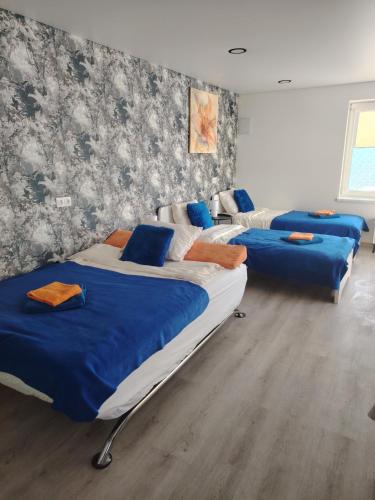 a group of four beds in a room at Jolsva in Rokiškis