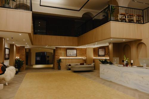 a large lobby with a reception desk and a couch at Pana Unique Semey in Semey