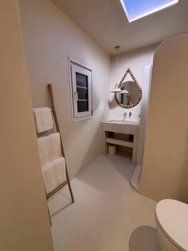 a bathroom with a toilet and a sink and a mirror at Dubai Escape Private Pool and Parking in Dubai