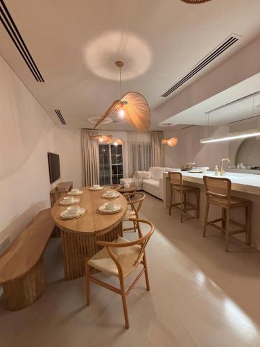 a kitchen and living room with a table and chairs at Dubai Escape Private Pool and Parking in Dubai