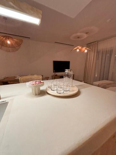a room with a table with glasses on it at Dubai Escape Private Pool and Parking in Dubai