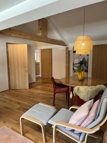 a living room with a table and chairs at Ari Apartment Wald am Arlberg in Wald am Arlberg