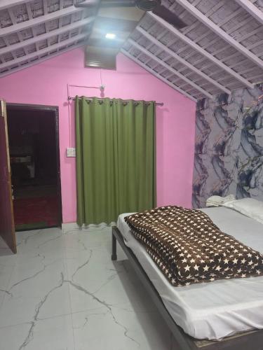 a bedroom with a bed and a green curtain at Full Moon Home Stay in Jamania