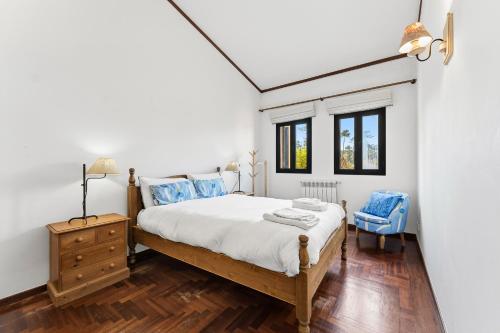 a bedroom with a bed and a dresser and windows at R3 - Miravillas - Rosas 33 in Mira