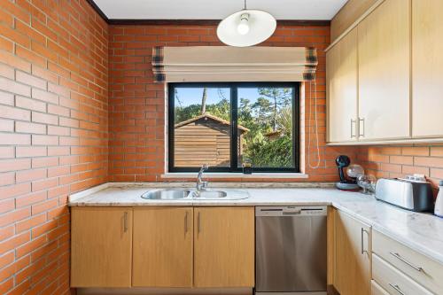 a kitchen with a sink and a window at R3 - Miravillas - Rosas 33 in Mira