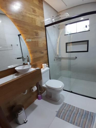 a bathroom with a toilet and a sink and a shower at Pousada Flor de Alter in Alter do Chao