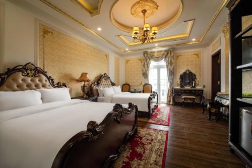 a hotel room with two beds and a piano at Dream Boutique Hotel in Da Lat