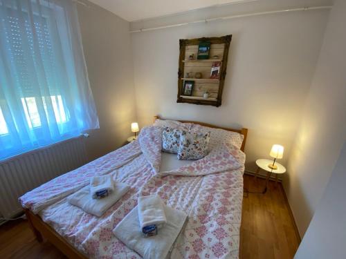 a bedroom with a bed with two towels on it at Panoráma Vendégház in Igal