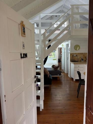 a room with a white door and a staircase at בקתות עץ סקנדינביות במטולה in Metulla