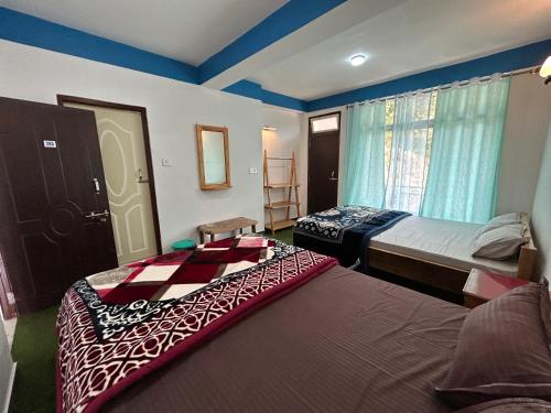 a hotel room with two beds and a window at Highpeak Hideway Homestay in Lava