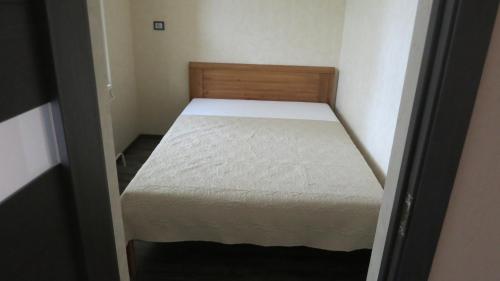 a small bedroom with a bed in a small room at Cat Garden Superior Apartments Riga in Rīga
