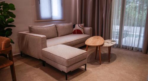 a living room with a couch and a chair at Cosmos Residences in Vasiliki