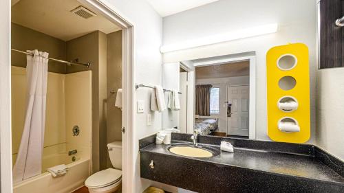 a bathroom with a sink and a toilet and a mirror at Motel 6-Wethersfield, CT - Hartford in Wethersfield