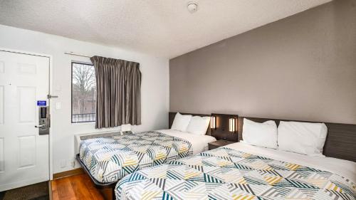 a room with two beds and a window at Motel 6-Wethersfield, CT - Hartford in Wethersfield