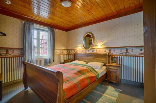 a bedroom with a bed and a mirror on the wall at Anker Brygge in Svolvær