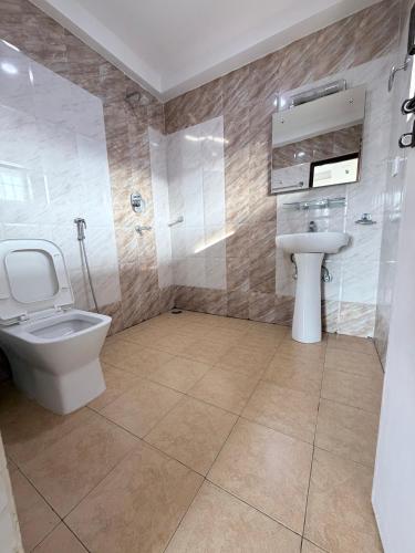 a bathroom with a toilet and a sink at Hotel K2 Pokhara in Pokhara