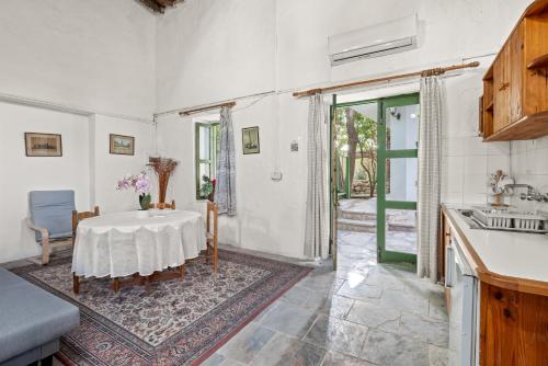 a kitchen with a table and a sink at Antonys Garden House in Episkopi Limassol