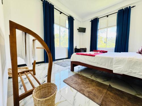 a bedroom with a bed and a chair and windows at Mist Cave Ella in Etimale