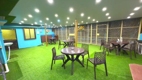 a restaurant with tables and chairs in a room at Classy5 Guest House in Varanasi