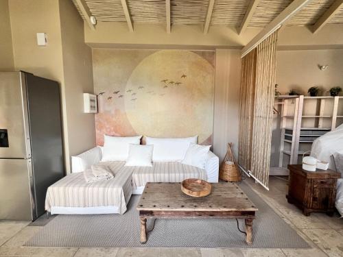 a living room with a couch and a table at FOS Ionian Breeze Studio in Platithriás