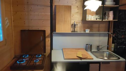 a small kitchen with a sink and a stove at Casa PerAria in Paluzza