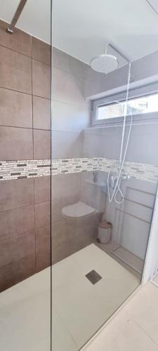 a bathroom with a shower with a glass door at Pinhão House in Pinhão