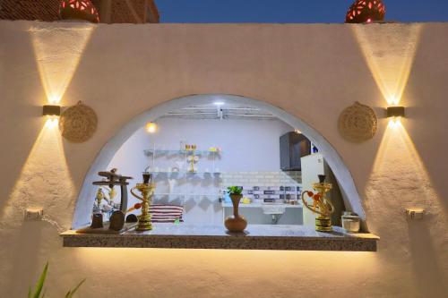 a room with a altar with vases and lights at White Gorf Hotel in Luxor