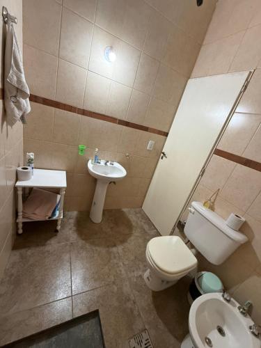 a bathroom with a toilet and a sink at Modo soto in Villa de Soto