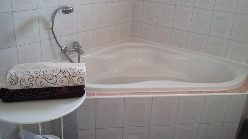a bath tub in a bathroom with a sink at Apartments Place4you in Bjelovar