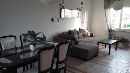 a living room with a table and a couch at Apartments Place4you in Bjelovar
