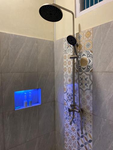 a bathroom with a shower with a shower head at Rasa Jogja Homestay in Yogyakarta