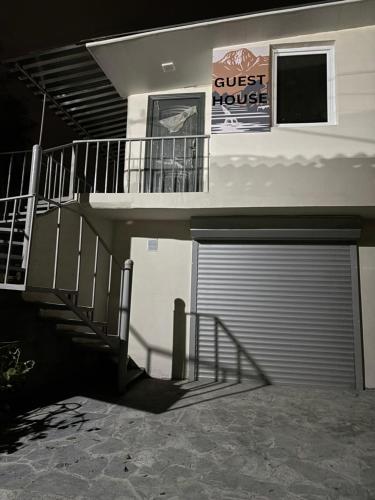 a building with a garage door and a guest house at Kapan Guesthouse in Kapan