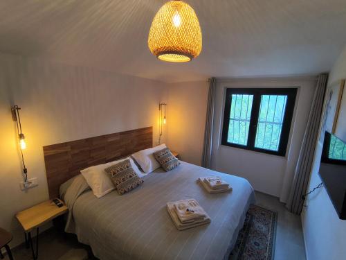 a bedroom with a bed with two trays on it at Il Verdone in Usini