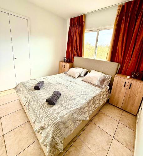 a bedroom with a bed with two shoes on it at Carisa rooms for holiday in Larnaca