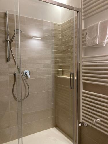a bathroom with a shower with a glass door at Camere Santucci in Assisi