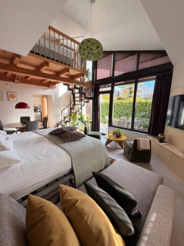 a large bedroom with a large bed and a couch at Apartments Pri nas in Kobarid