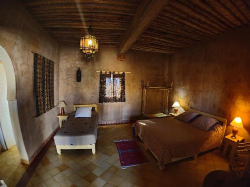 a bedroom with a bed and a chair in a room at Auberge Merzane in Merzane
