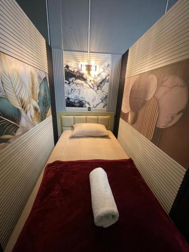 a small bedroom with a bed with a red blanket at Dream Moon Hostel in Haad Rin