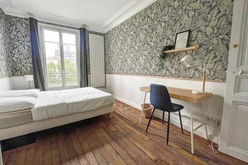 a bedroom with a bed and a desk and a window at Room in elegant 3-bedroom apartment near Bois de Vincennes in Paris