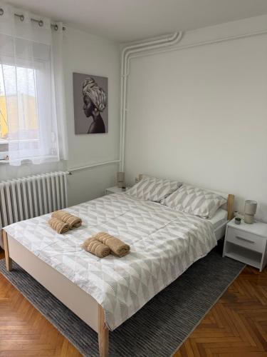 a bedroom with a large bed with two pillows on it at AG Apartman in Kraljevo