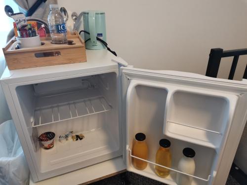 an open refrigerator with drinks inside of it at A to B Hotel in London