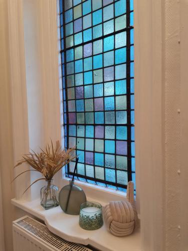 a window with a colorful stained glass window at A to B Hotel in London