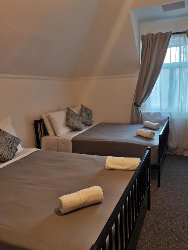 a bedroom with two beds and a window at A to B Hotel in London
