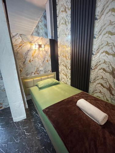 a bedroom with a bed with a towel on it at Dream Moon Hostel in Haad Rin
