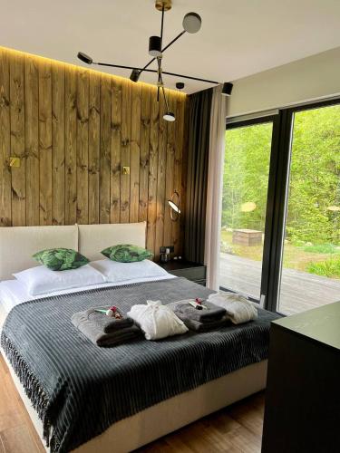 a bedroom with a large bed with towels on it at Paporoti House in Korostov