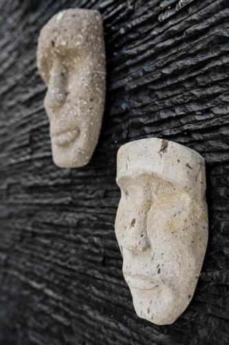 a statue of a head on a wall at CASA LIMA- Executive Design Suites in Cancún